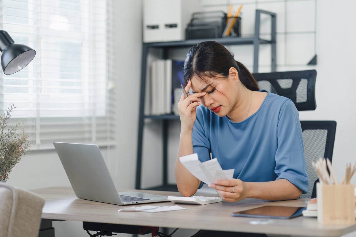 UK director discovering a frozen business bank account while reviewing finances on a laptop