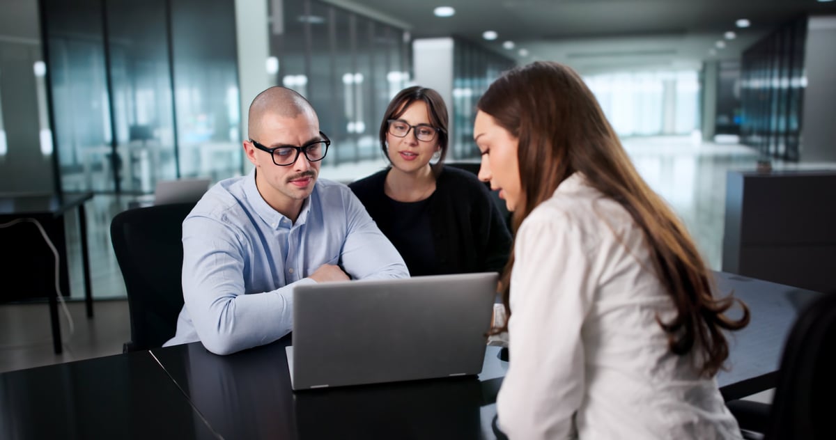 Financial planner providing tax advice to business clients at office