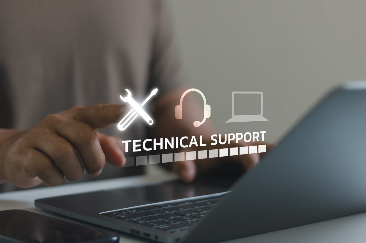 Close-up of business professional using laptop with virtual technical support icons, highlighting customer assistance, helpdesk, digital solutions and online support technology concept